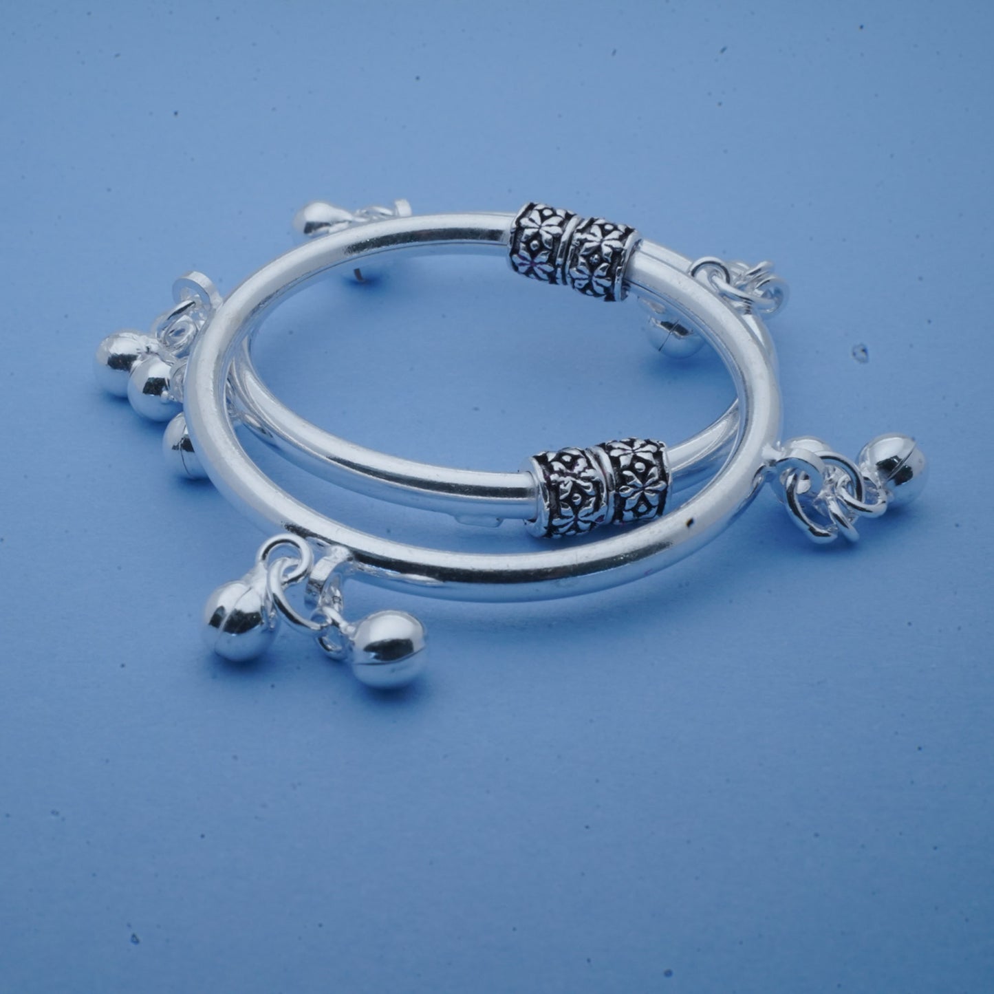 silver kada pair for kids with black polish and ghunghroos
