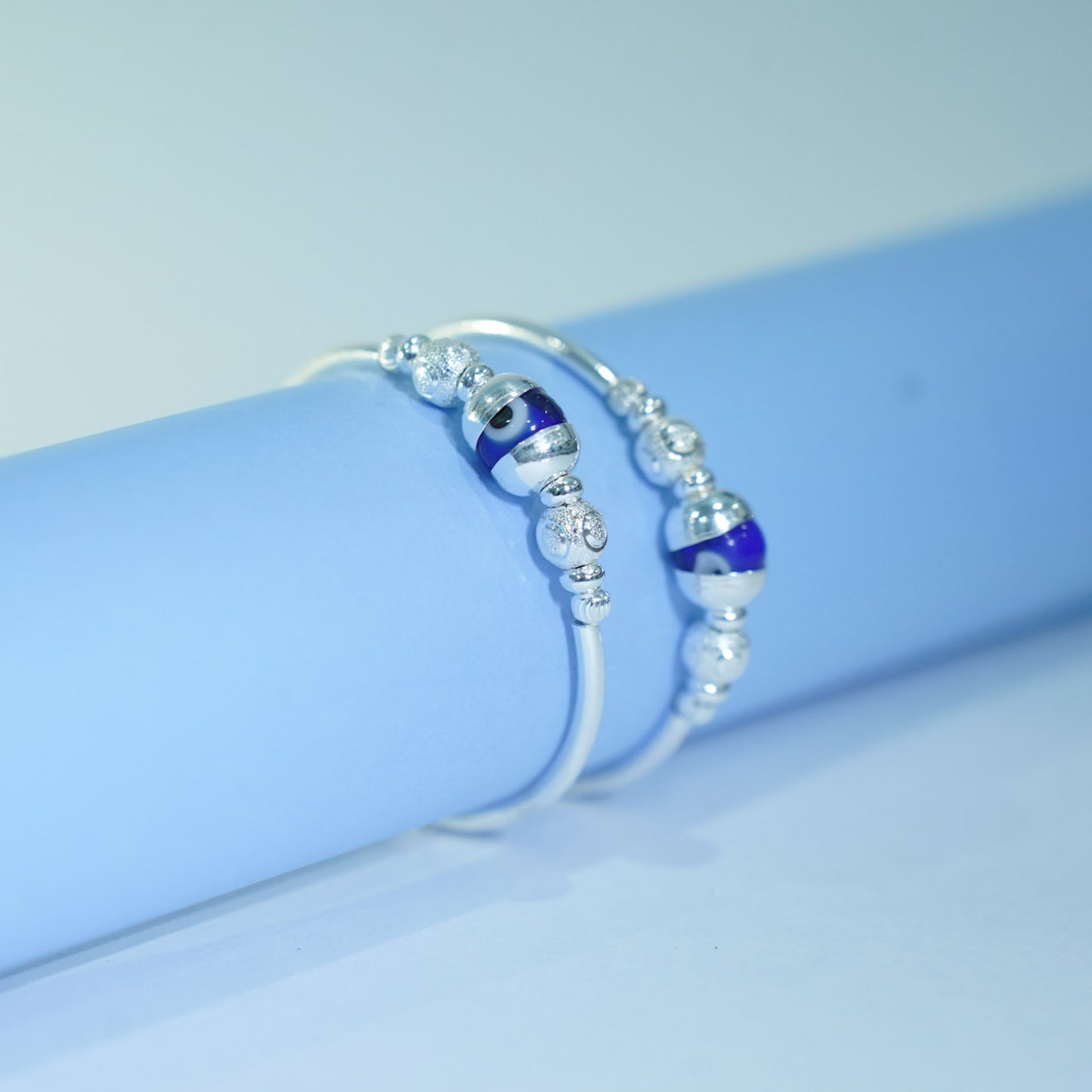 silver kada pair for kids with blue evil eye and silver balls