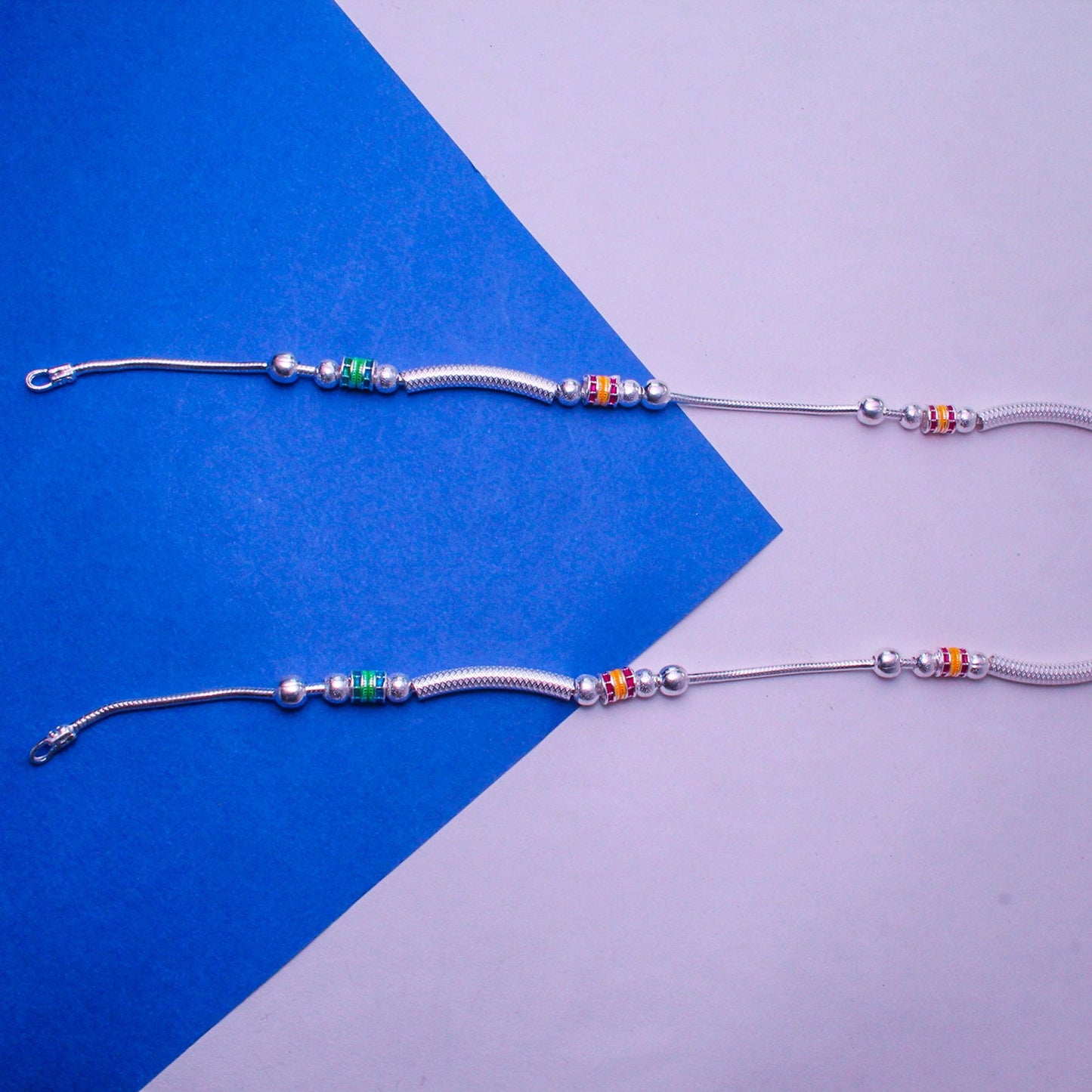 stylish dimple design silver payal with red and green accents | shyni - shyni jewellery