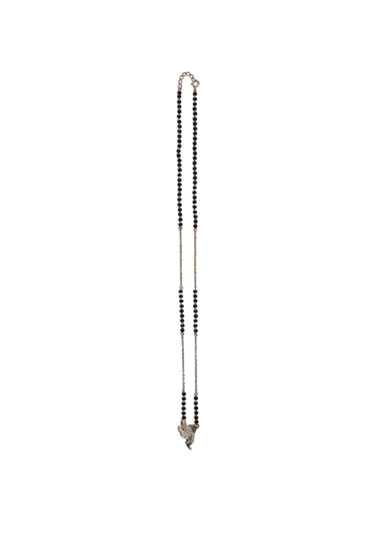 A delicate silver-toned chain necklace with small black beads, laid flat on a plain beige background.


