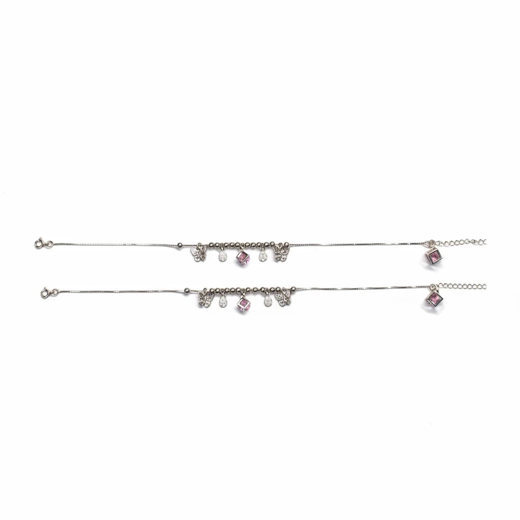 shyni jewelry silver charm anklet set featuring delicate butterfly charms and pink crystal accents on a thin chain.