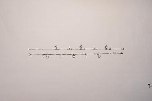 Shyni Jewelry silver charm anklets featuring delicate chains with sparkling round and teardrop-shaped charms