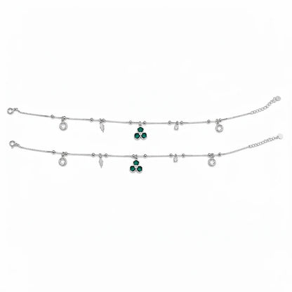 Shyni Jewelry silver charm anklet featuring green clover-shaped stones, clear crystals, and delicate metal charms.