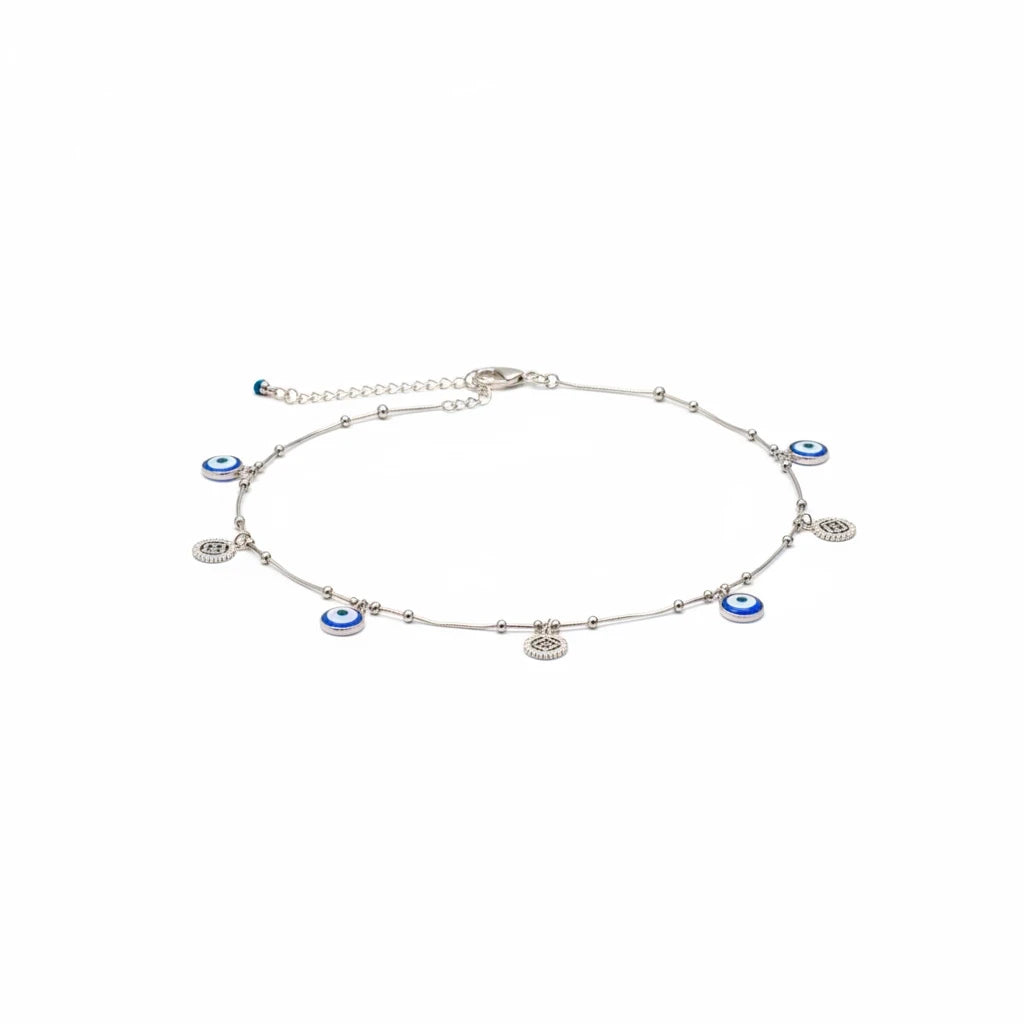 shyni jewelry silver anklet featuring blue and white evil eye charms and small metallic beads on a delicate chain.