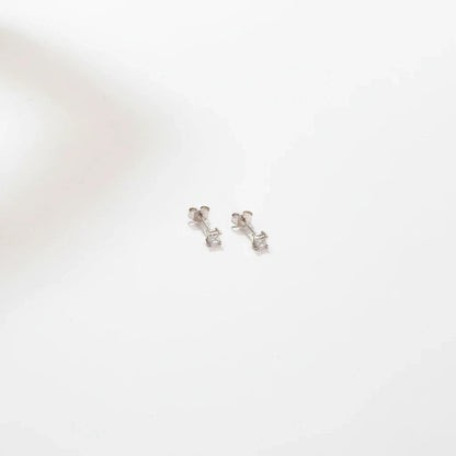 Shyni Jewelry square-shaped silver stud earrings with a single clear stone on a minimalist white background
