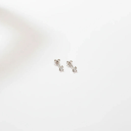 Shyni Jewelry square-shaped silver stud earrings with a single clear stone on a minimalist white background